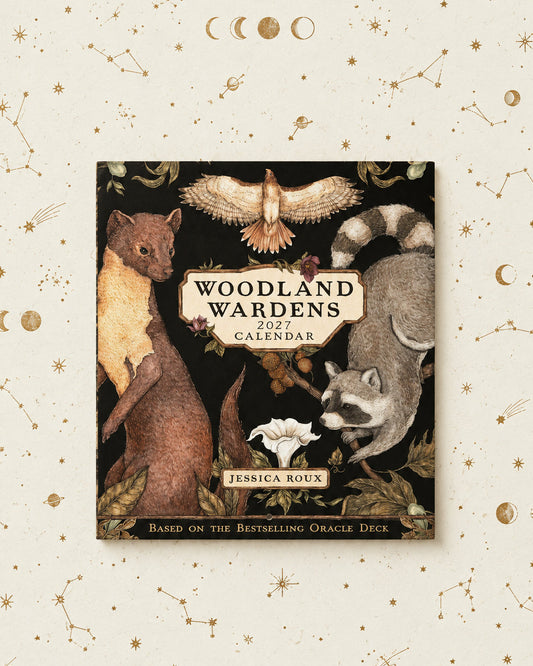 'Woodland Wardens 2027 Calendar' by Jessica Roux, featuring detailed illustrations of woodland animals including a mink, raccoon, owl, and white flower on a dark background, framed by a light beige decorative border with celestial motifs.